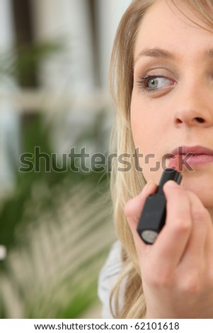 Portrait of a woman making up lips