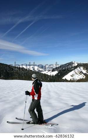 Man on skis face to a snowy landscape