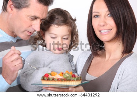Portrait of family eating a fruit pie