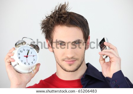 Man With An Alarm Clock And A Mobile Phone In Hand Stock Photo 65206483 ...