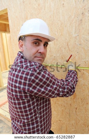 Craftsman working on a house under construction