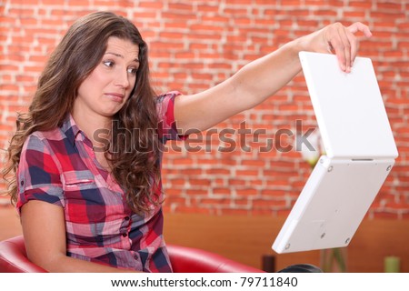 Woman disgusted by her laptop