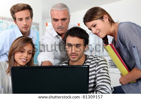 group of people watching a screen