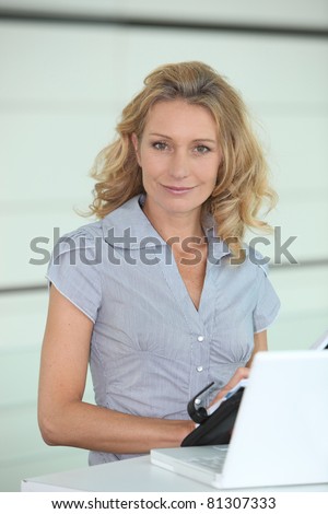 Smiling woman putting a date in her diary