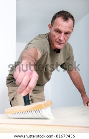 Man applying wallpaper paste