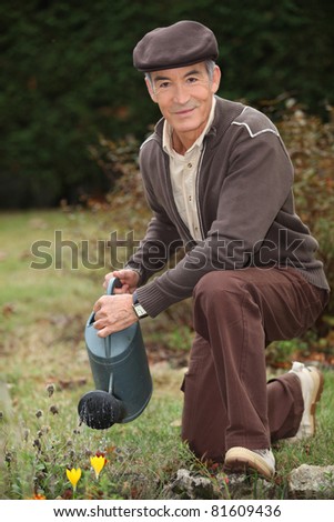 Man watering plants in his garden