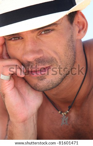 Man in a straw hat on a beach