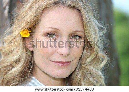 blonde woman with flower in hair