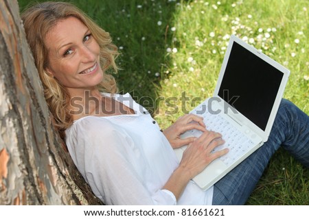 Woman on laptop outside