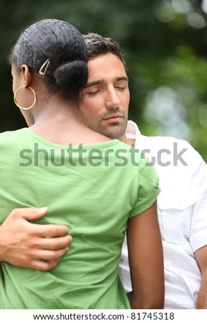 a man comforting his wife