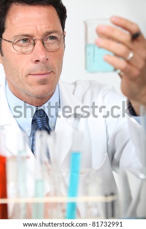 Male scientist holding glass beaker
