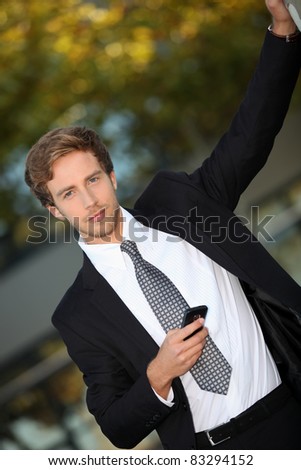 Young man in smart suit with mobile phone