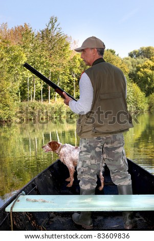 Hunter on boat with dog