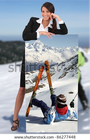 businesswoman at ski leaning on picture of herself printed on canvas