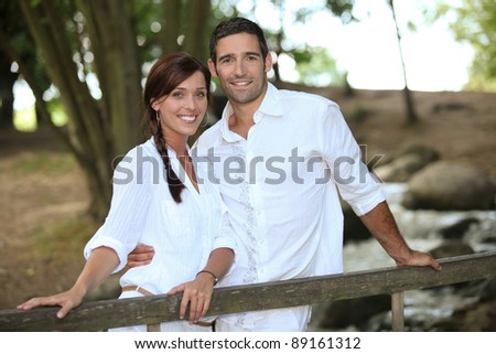 Attractive couple taking a summer stroll through the woods
