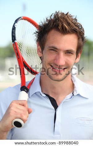 Male tennis player holding racquet over shoulder