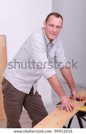 craftsman measuring a wooden board