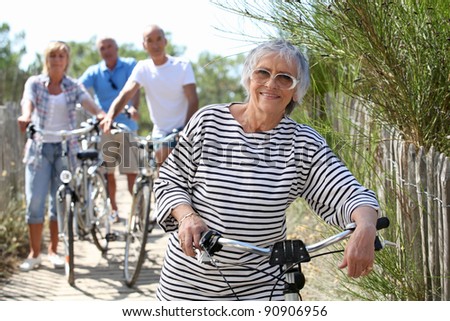 Middle-aged people on bike ride at the beach