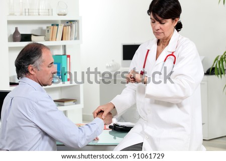 A doctor taking her patient pulse rate.