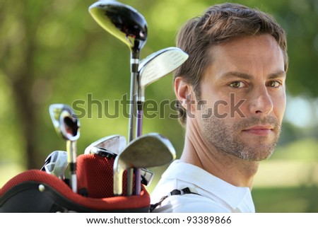 Man carrying golf bag