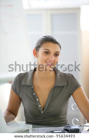 Casual office worker sat at her desk