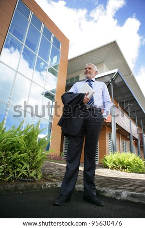 Director standing in front of his company