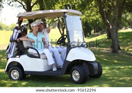 Couple in golf buggy
