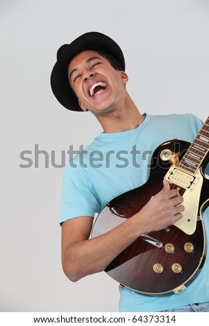 Young man M?tis playing electric guitar Photo stock © 