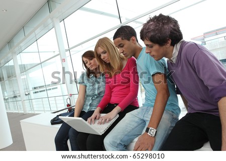 Young students sitting in front of a laptop computer Photo stock © 