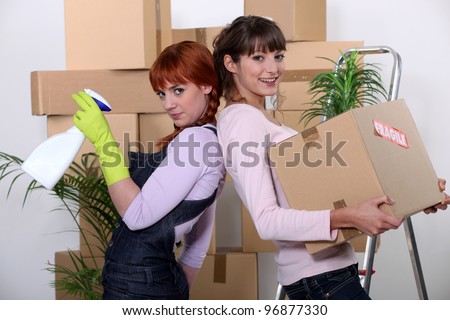 Young women cleaning out their apartment on moving day