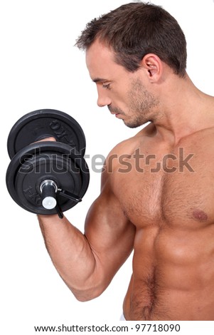bare-chested and muscular man doing fitness with dumbbell