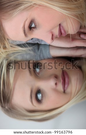 Face of woman reflected in mirror