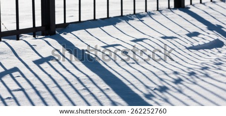 winter sunny day and the shadow of the snow from the lattice