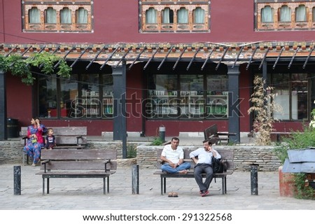 THIMPHU, BHUTAN - JUN 4, 2014: Local People relax around Clock Tower Square, famous landmark in Thimphu, Bhutan on Jun 4, 2014.