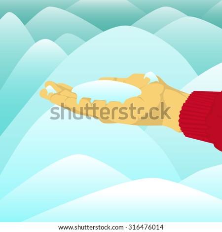 Hand holding a pile of snow near snow