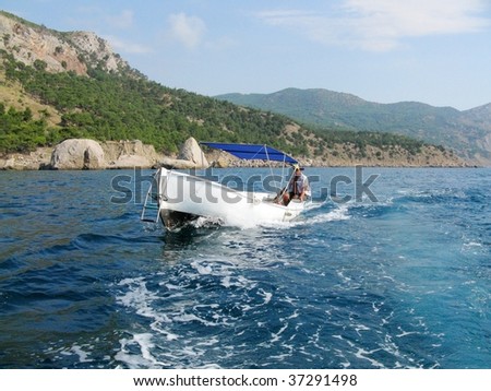 Man driving a boat in the sea