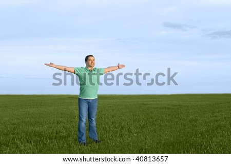 man take energy from nature in the meadow with dark blue sky