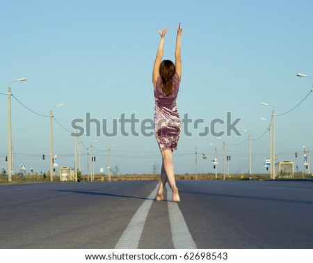 girl in  dress walk barefoot on empty road