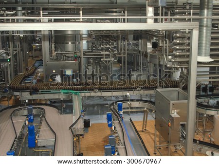 Moscow, Russian Federation, March 07, 2015: Plastic water bottles on conveyor or water bottling machine