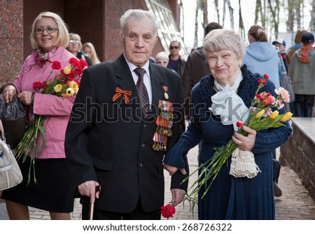 UFA,RUSSIA - MAY 9, 2013: Couple of World War II veterans smile to camera in Victory Park during festivities devoted to Victory Day on May 9 at Ufa