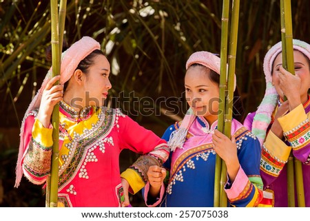 KUNMING,CHINA -  FEBRUARY 15: Lahu women rest after a dance performance in Yunnan Minority Village, Kunming, China, on February 15th, 2015. Lahu people are one of 26 ethnic minorities living in Yunnan