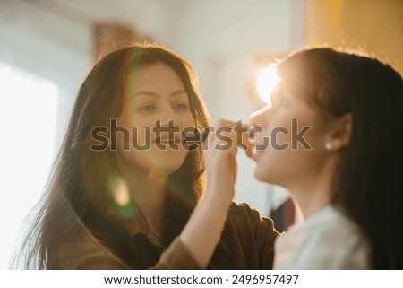 Similar – Image, Stock Photo Makeup artist doing makeup for young female artist