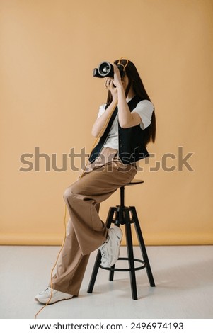 Similar – Image, Stock Photo Female photographer working on photos on laptop and camera