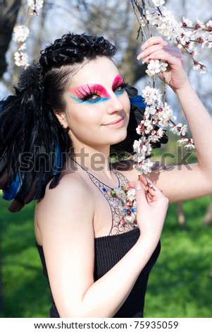 Spring portrait of a raven girl with unusual makeup