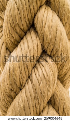 A closeup shot of cream colored rope showing texture and weaving