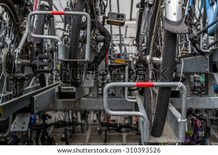 CHELMSFORD/ESSEX - ENGLAND 16TH AUGUST 2015 - Many commuter bikes parked and locked outside a train station in Chelmsford Essex in August 2015 provide ecological friendly transport for passengers