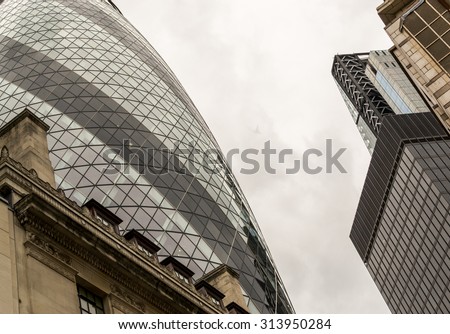 LONDON - ENGLAND 18TH AUGUST 2015 - Famous London Gherkin Building with white sky dominates the surrounding office building skyline in August 2015