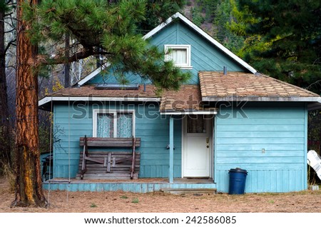Old blue wood siding house: summer cottage in Tulameen, BC ghost-town
