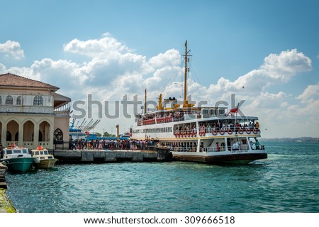 Istanbul, Turkey - August 24, 2015: People are getting on the ferry boat in Kadikoy. Every day nearly 150,000 passengers use ferries in Istanbul.