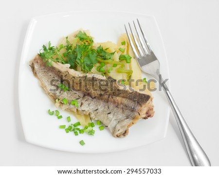 Fried fish with vegetables on square plate